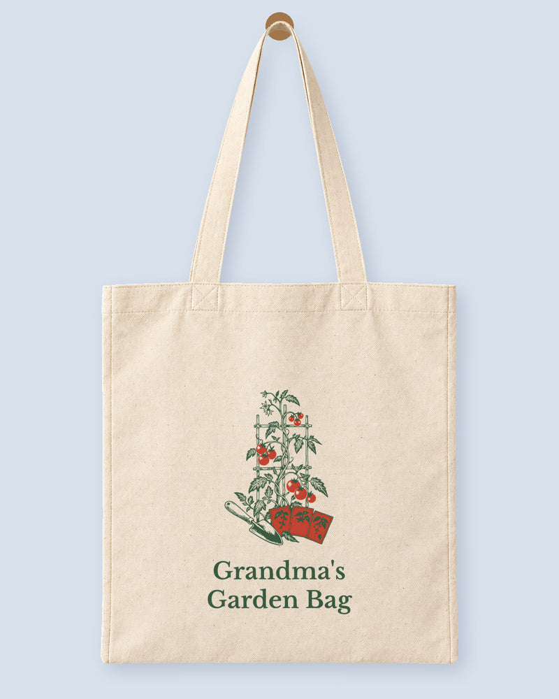 Natural canvas tote printed with “Grandma's Garden Bag”, hanging on a wooden peg.