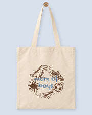 Natural canvas tote printed with “mom of boys”, hanging on a wooden peg.