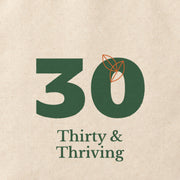 Close-up of the “Thirty & Thriving” print on cotton canvas.