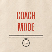 Close-up of the “COACH MODE” print on cotton canvas.
